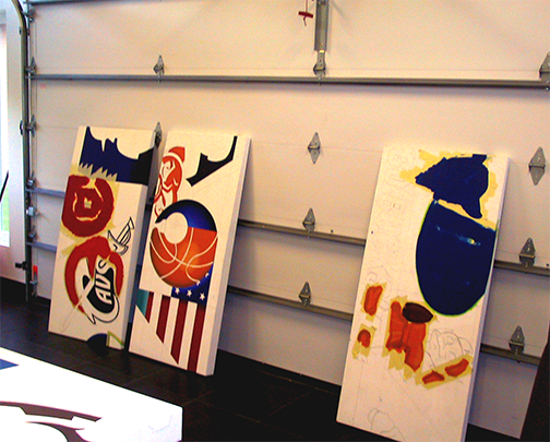 Partially painted canvas-panels waiting their turn in the rotation.