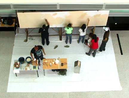 Aditya Tobing and volunteer students at BINUS university priming mural canvas