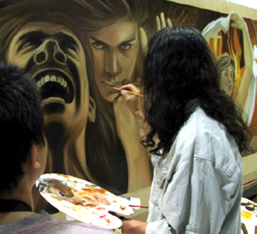 john rivera-resto applying final touches to the painting at binus university