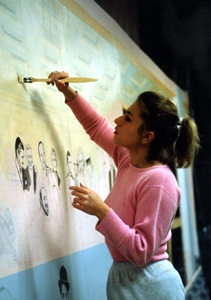 Karyl applying a coating of thin paint to seal the background drawing